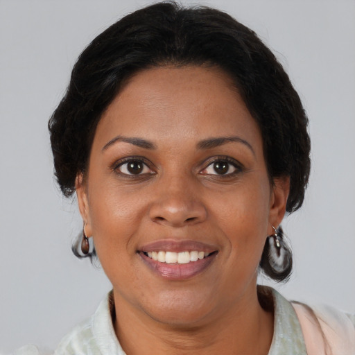 Joyful black young-adult female with medium  brown hair and brown eyes