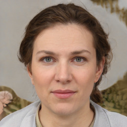 Joyful white young-adult female with medium  brown hair and grey eyes