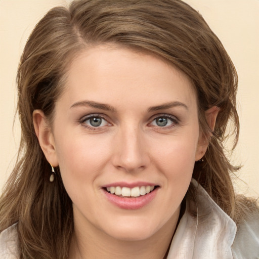 Joyful white young-adult female with long  brown hair and green eyes