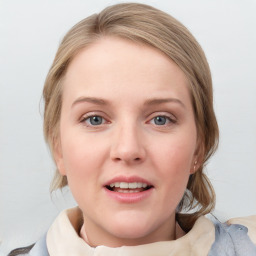 Joyful white young-adult female with medium  brown hair and blue eyes