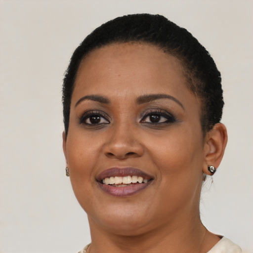 Joyful latino young-adult female with short  black hair and brown eyes