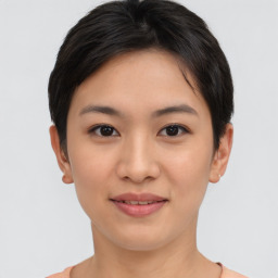 Joyful asian young-adult female with short  brown hair and brown eyes