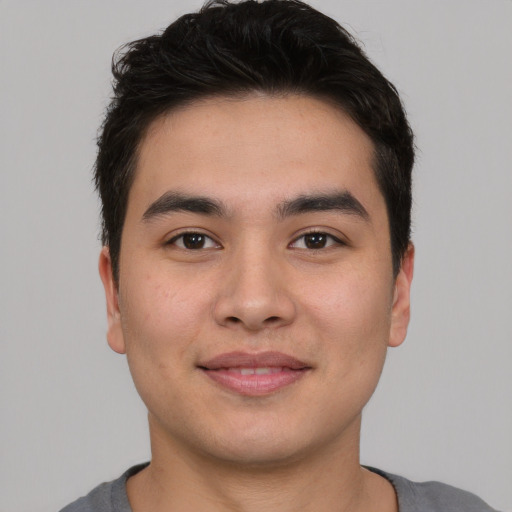 Joyful asian young-adult male with short  brown hair and brown eyes