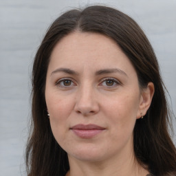 Joyful white adult female with long  brown hair and brown eyes