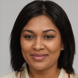 Joyful black young-adult female with medium  brown hair and brown eyes