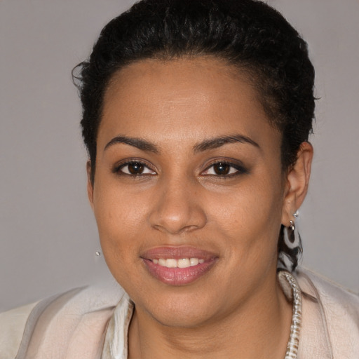 Joyful black young-adult female with short  brown hair and brown eyes