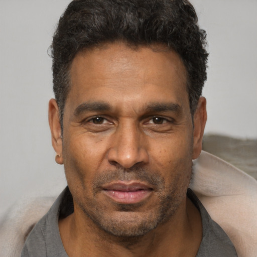 Neutral latino adult male with short  black hair and brown eyes
