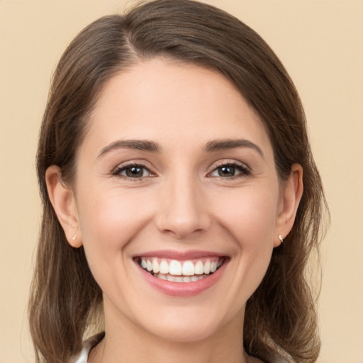 Joyful white young-adult female with medium  brown hair and brown eyes