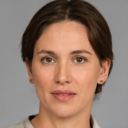 Joyful white adult female with medium  brown hair and grey eyes