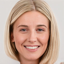 Joyful white young-adult female with long  brown hair and blue eyes