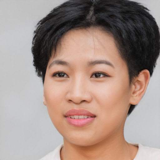 Joyful asian young-adult female with short  brown hair and brown eyes