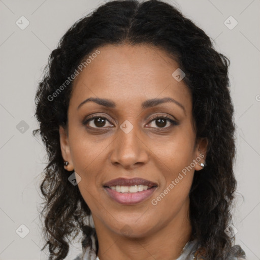 Joyful black adult female with long  brown hair and brown eyes