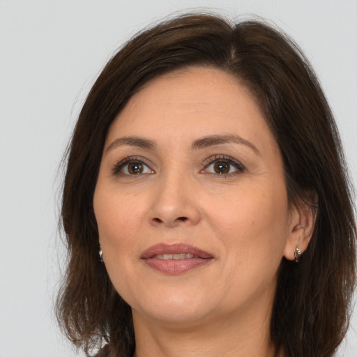 Joyful white adult female with medium  brown hair and brown eyes