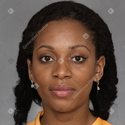 Joyful black young-adult female with long  brown hair and brown eyes