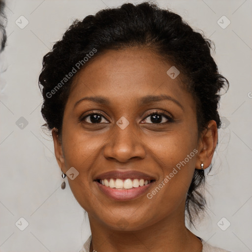 Joyful black young-adult female with medium  brown hair and brown eyes