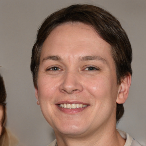 Joyful white adult male with medium  brown hair and brown eyes