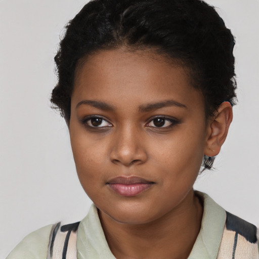 Joyful black young-adult female with short  brown hair and brown eyes