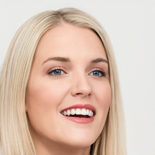 Joyful white young-adult female with long  brown hair and blue eyes