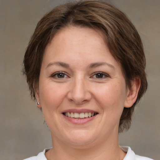 Joyful white adult female with medium  brown hair and brown eyes