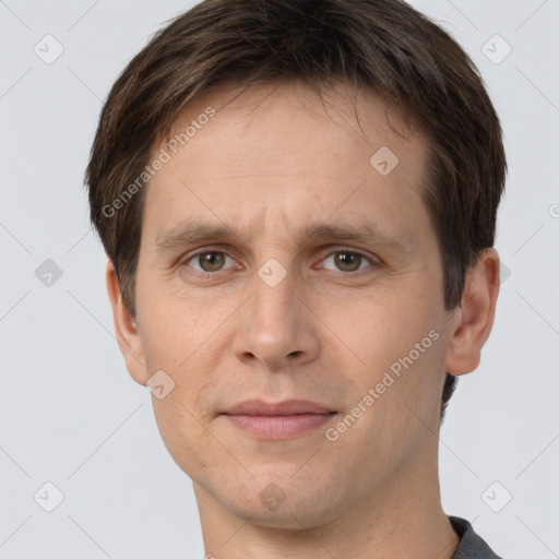 Joyful white adult male with short  brown hair and grey eyes