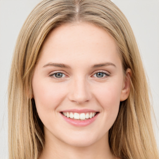 Joyful white young-adult female with long  brown hair and green eyes