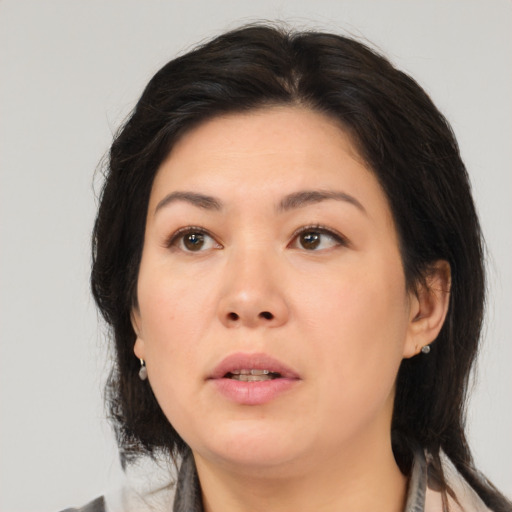 Neutral asian adult female with medium  brown hair and brown eyes