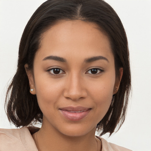 Joyful latino young-adult female with medium  brown hair and brown eyes