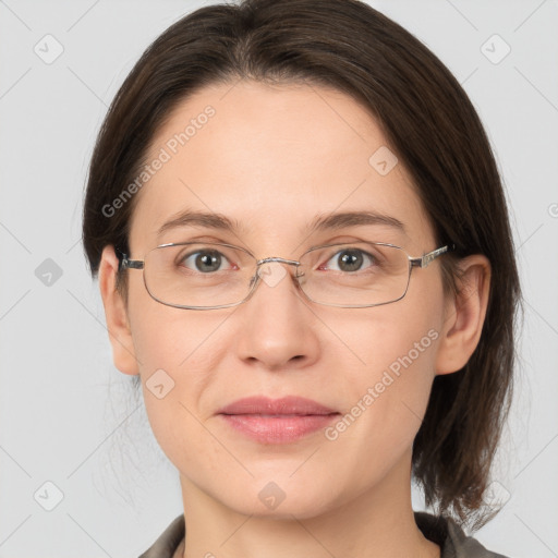 Joyful white adult female with medium  brown hair and grey eyes