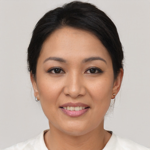 Joyful asian young-adult female with short  brown hair and brown eyes