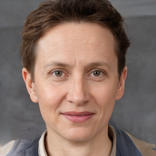 Joyful white adult female with short  brown hair and grey eyes