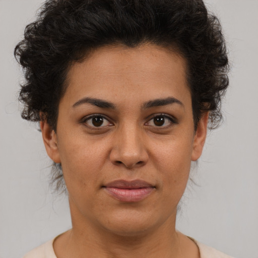 Joyful latino young-adult female with short  brown hair and brown eyes