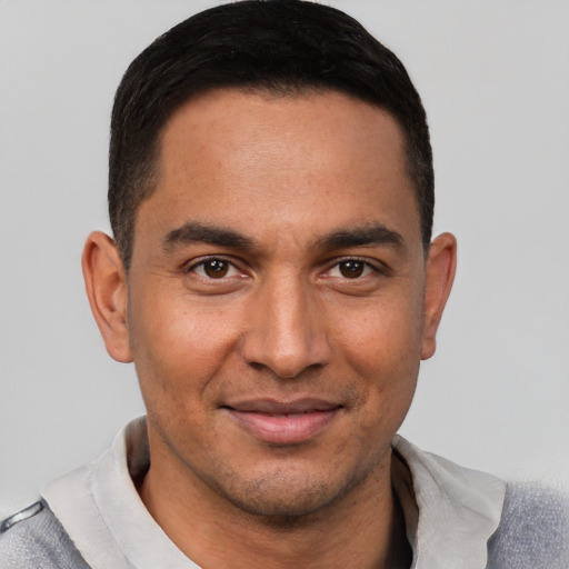 Joyful white young-adult male with short  black hair and brown eyes