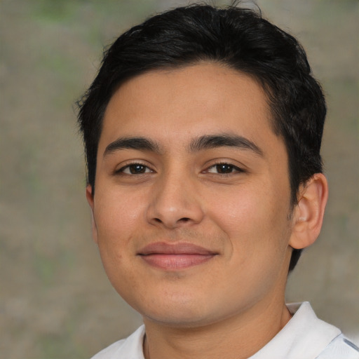 Joyful latino young-adult male with short  brown hair and brown eyes