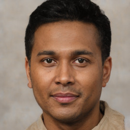 Joyful latino young-adult male with short  black hair and brown eyes