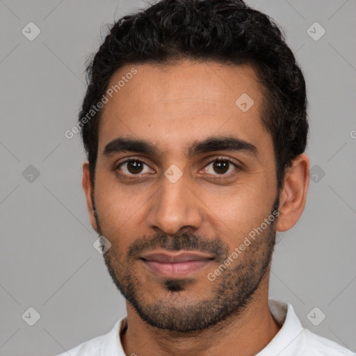 Joyful latino young-adult male with short  black hair and brown eyes