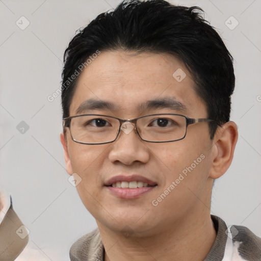 Joyful asian young-adult male with short  black hair and brown eyes