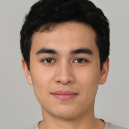 Joyful asian young-adult male with short  black hair and brown eyes