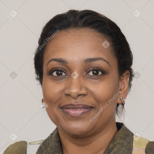 Joyful black adult female with medium  brown hair and brown eyes