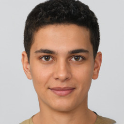 Joyful latino young-adult male with short  brown hair and brown eyes