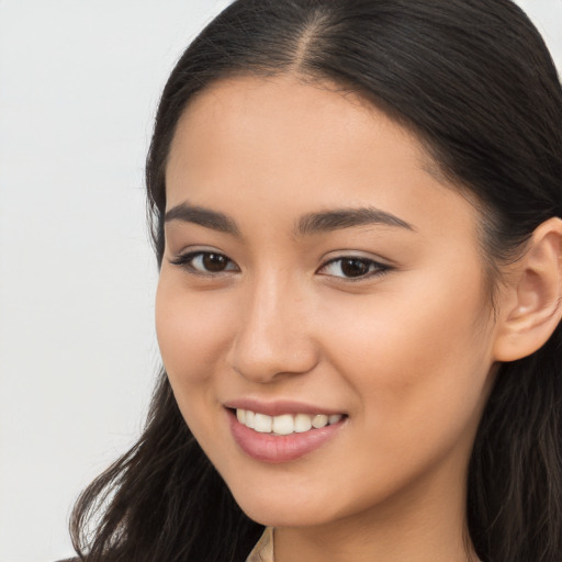 Joyful latino young-adult female with long  brown hair and brown eyes