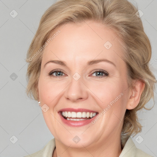 Joyful white adult female with medium  brown hair and blue eyes