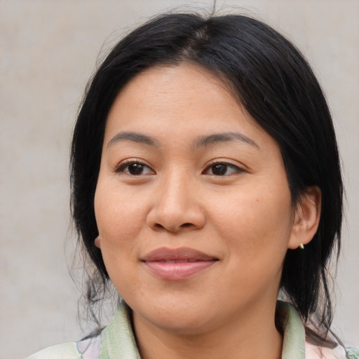 Joyful asian young-adult female with medium  brown hair and brown eyes