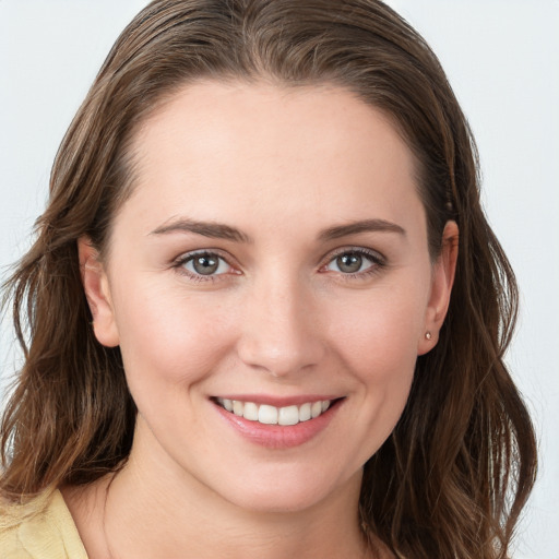 Joyful white young-adult female with medium  brown hair and grey eyes