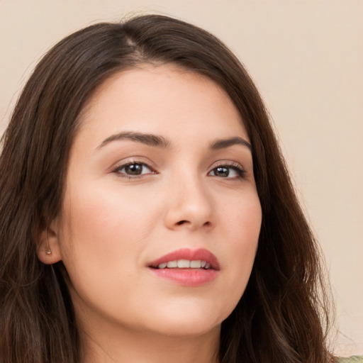 Joyful white young-adult female with long  brown hair and brown eyes