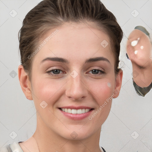 Joyful white young-adult female with short  brown hair and grey eyes