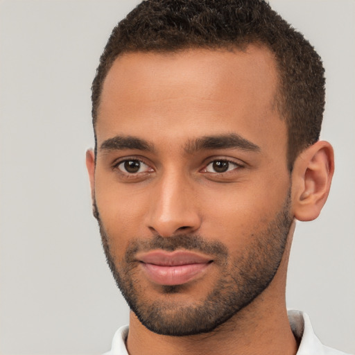 Joyful black young-adult male with short  brown hair and brown eyes