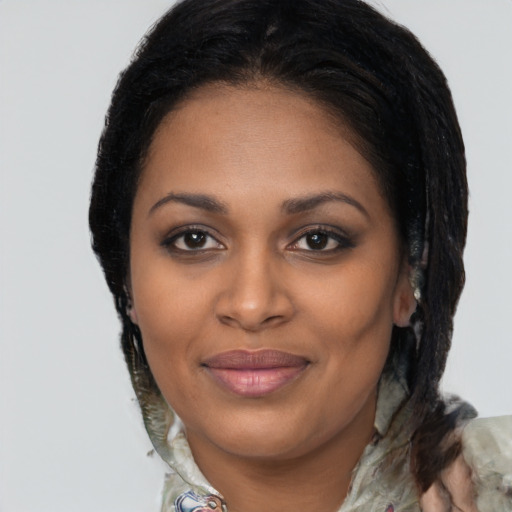 Joyful black young-adult female with medium  brown hair and brown eyes