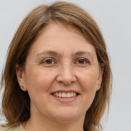 Joyful white adult female with medium  brown hair and brown eyes