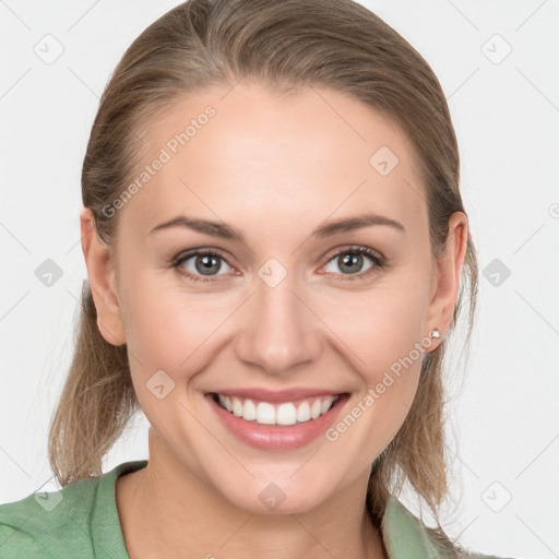 Joyful white young-adult female with medium  brown hair and grey eyes