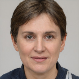 Joyful white adult female with short  brown hair and brown eyes